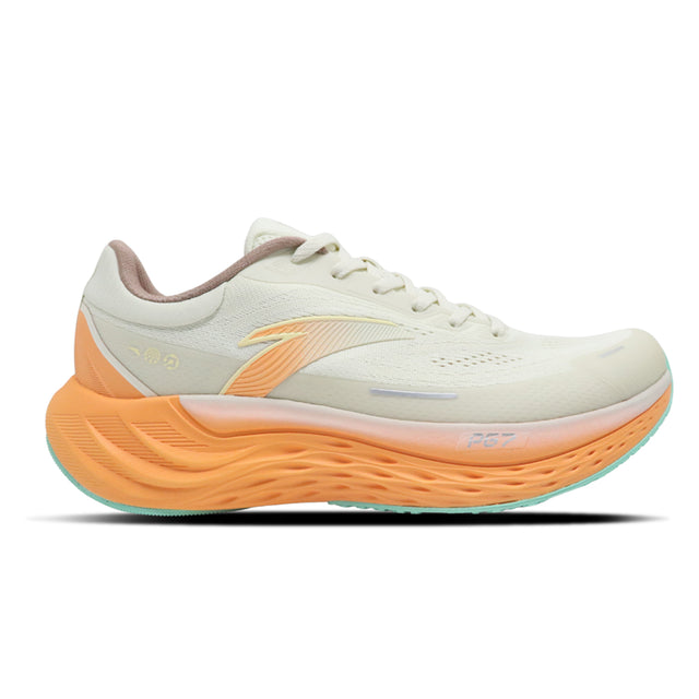 White running shoe with orange sole on a white background