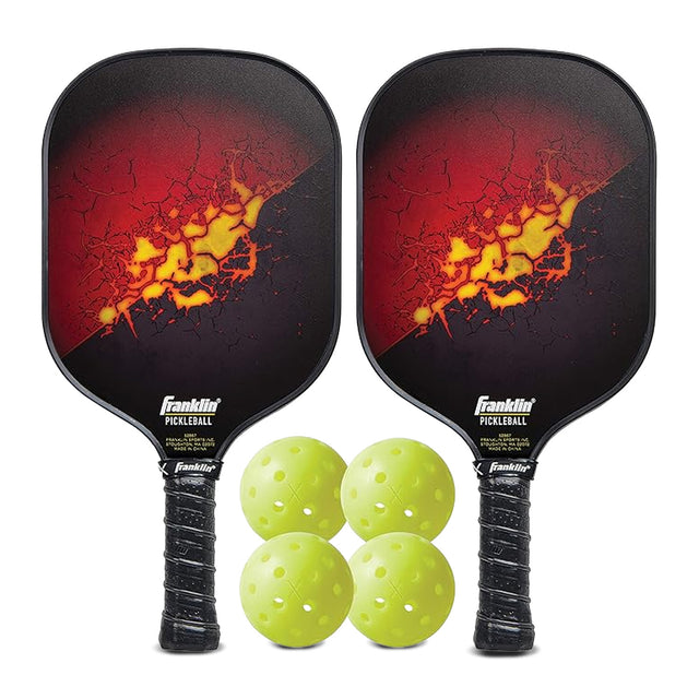 Two pickleball paddles with a fiery design and four green pickleballs on a white background.
