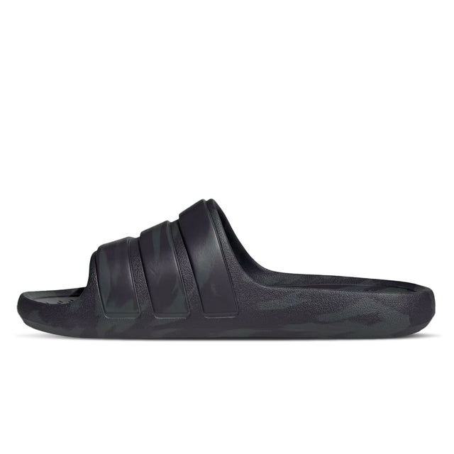 A pair of black adidas Adilette Flow slides with a one-piece moulded design.