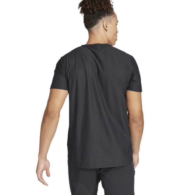 Person wearing a black t-shirt on a white background
