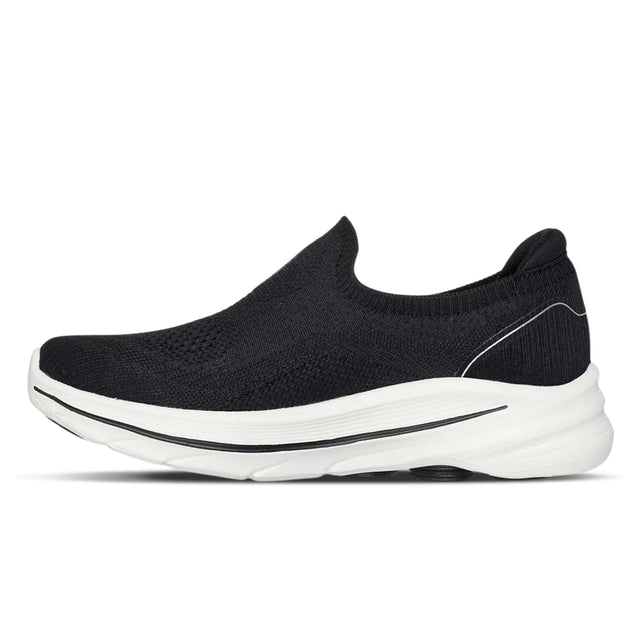 Black slip-on shoe with white sole on a white background