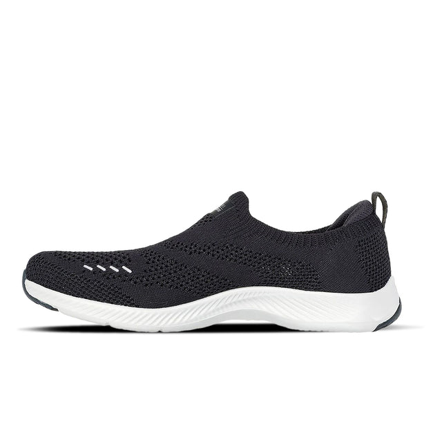 Black slip-on sneaker with white sole on a white background