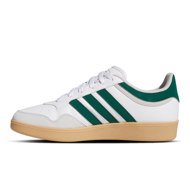White sneaker with green stripes and brown sole on a white background
