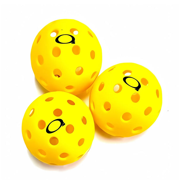 Three yellow pickleball balls with black dots on a white background