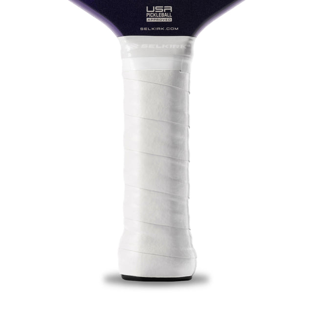 Close-up of a pickleball paddle with a white grip and purple top on a white background