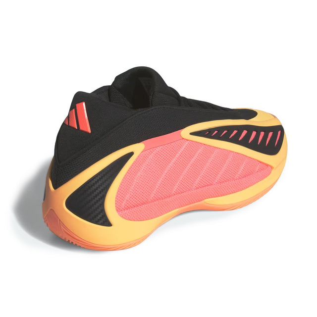 Black, pink, and yellow athletic shoe on a white background
