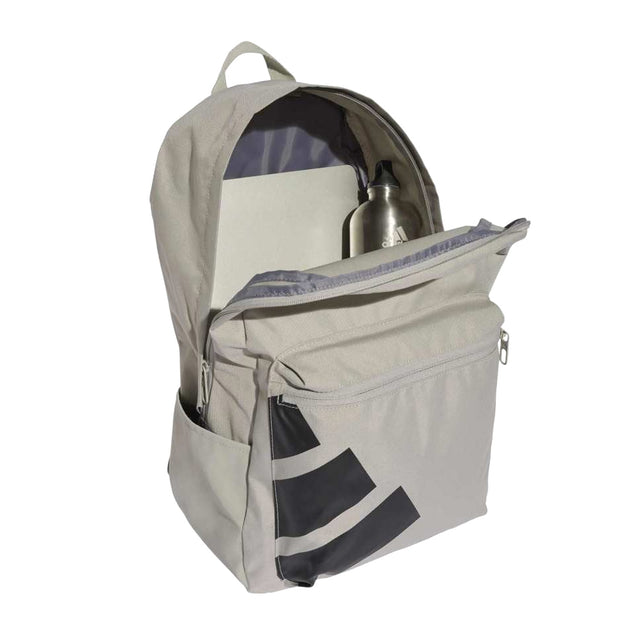 Beige backpack with a water bottle and notebook on a white background