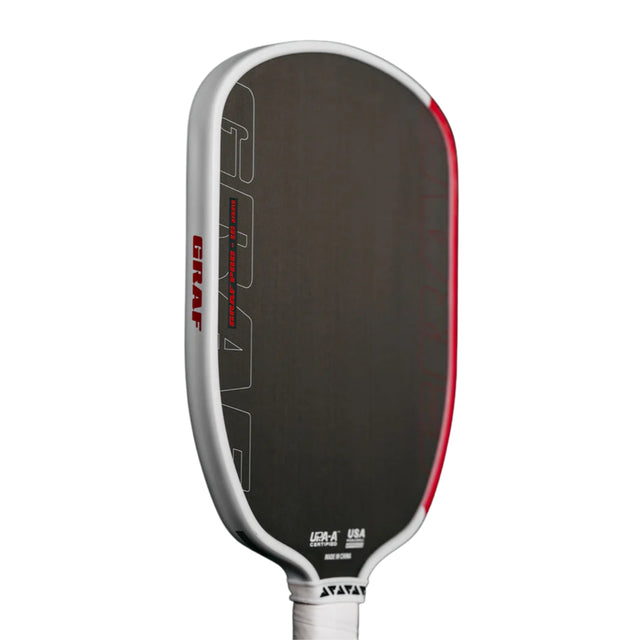 Pickleball paddle with black surface, red edges, and white handle on a white background