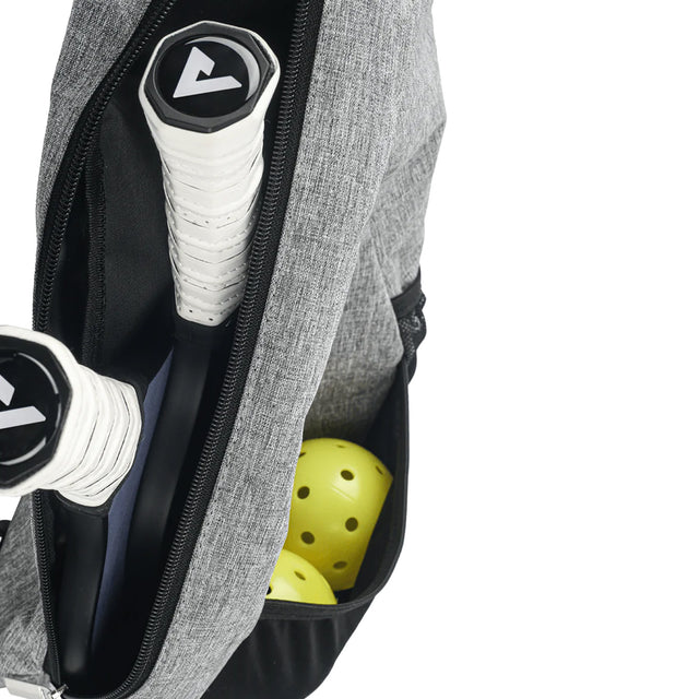 Gray golf bag with golf clubs and a yellow ball inside