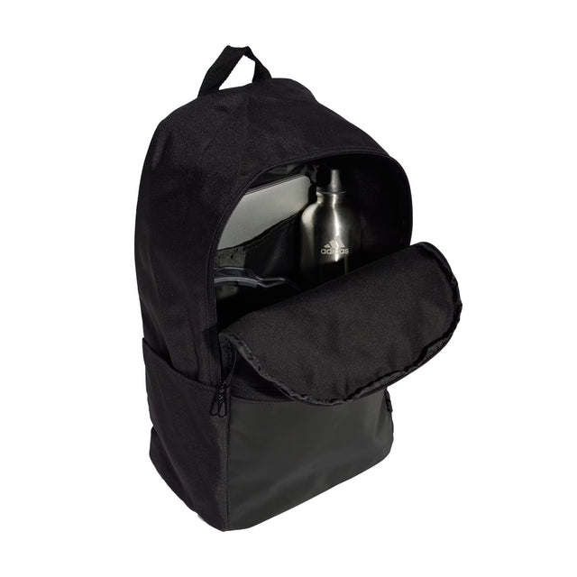Black backpack with a water bottle inside on a white background