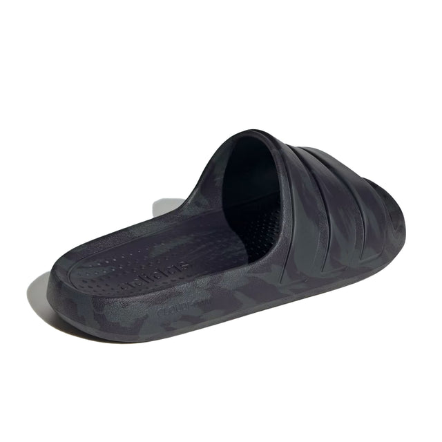 A pair of black adidas Adilette Flow slides with a one-piece moulded design.