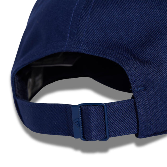 Close-up of a blue cap with a visible brand logo on a white background