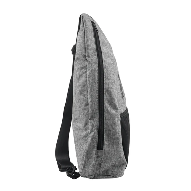 Gray sling bag with black straps on a white background