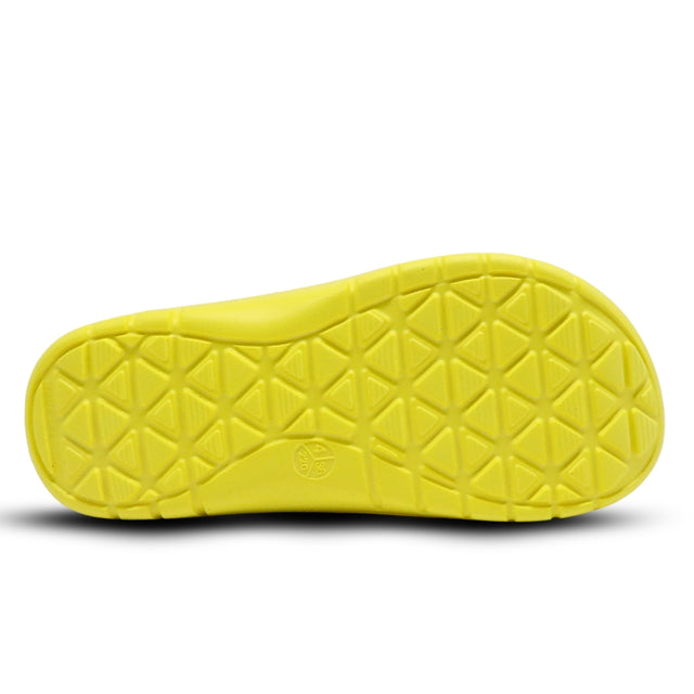 Close-up of a yellow sandal sole with textured pattern on a white background