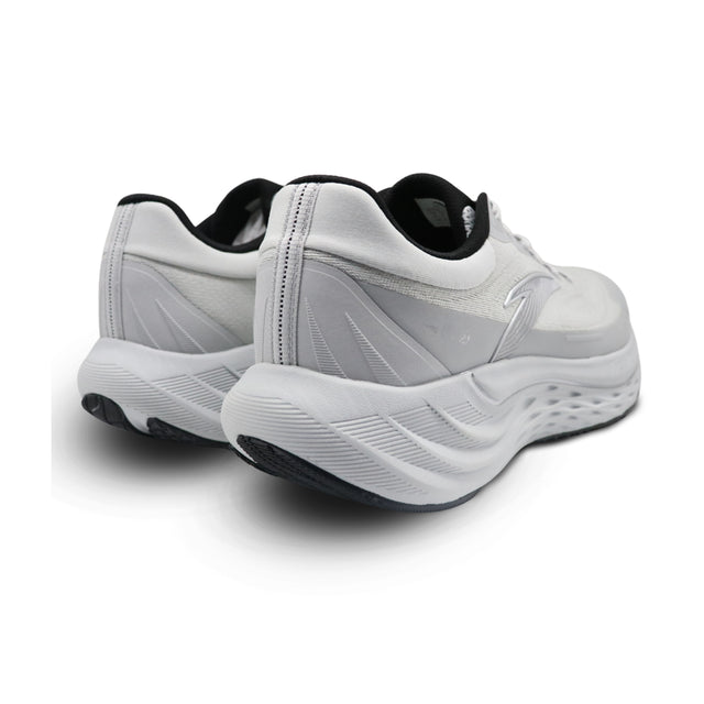 White athletic shoes with black soles on a white background