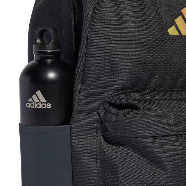 Black Adidas water bottle in a backpack pocket with Adidas logo on backpack.