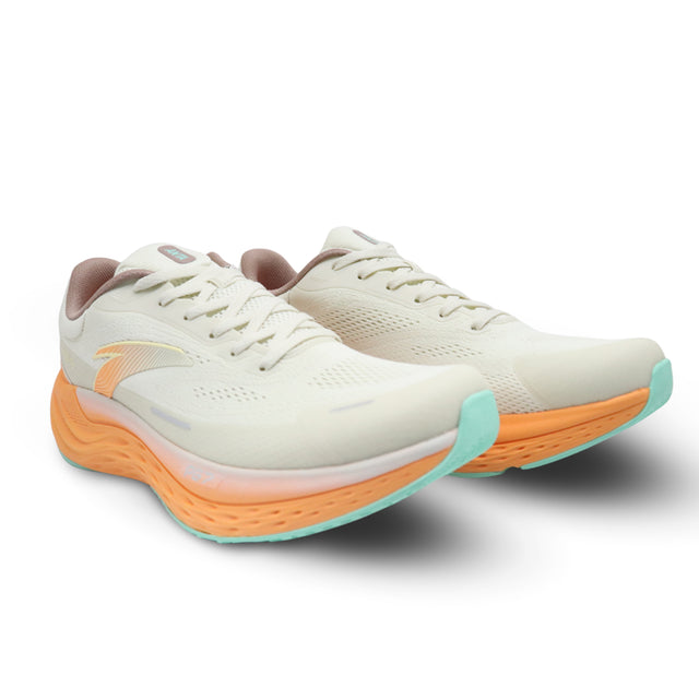Pair of white running shoes with orange and teal soles on a white background
