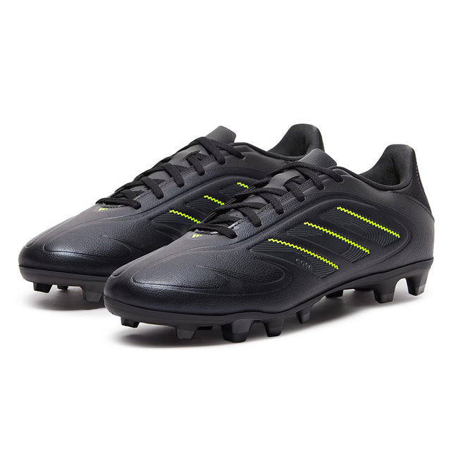 Black soccer cleats with yellow accents on a white background