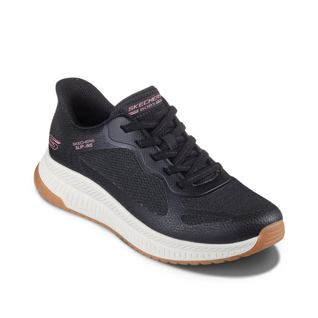 Black sneaker with brown sole on a white background