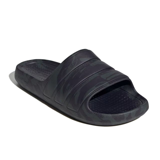 A pair of black adidas Adilette Flow slides with a one-piece moulded design.