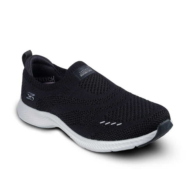 Black slip-on sneaker with white sole on a white background
