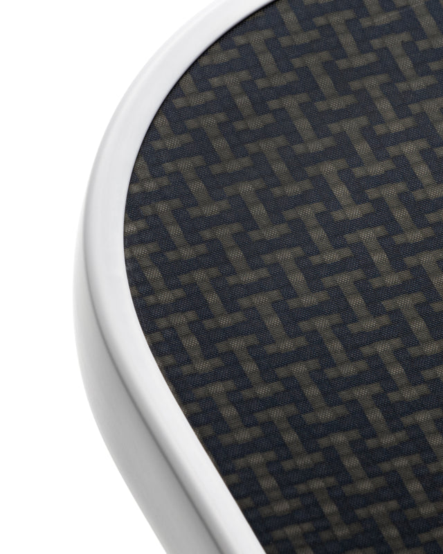 Close-up of a textured circular object with a geometric pattern on a white background