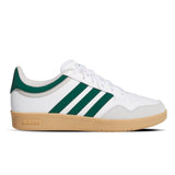 White Adidas sneaker with green stripes and brown sole on a white background