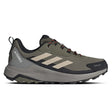 Green hiking shoe with black sole on a white background