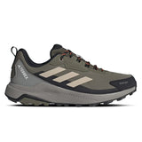 Green hiking shoe with black sole on a white background