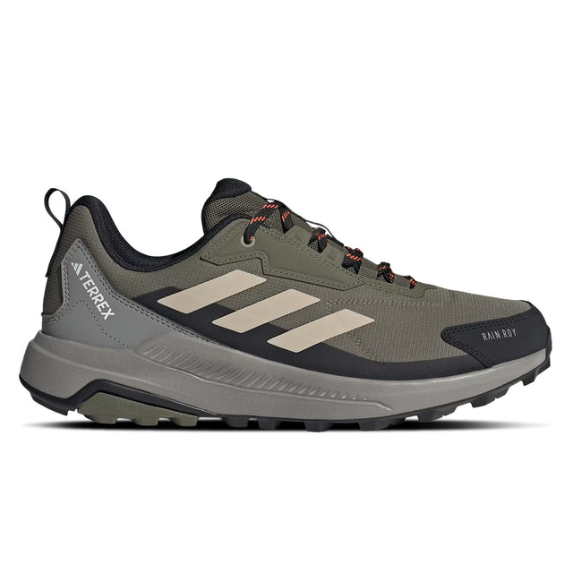 Green hiking shoe with black sole on a white background