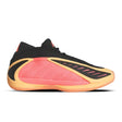 Black, pink, and yellow athletic shoe on a white background