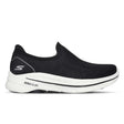 Black slip-on sneaker with white sole on a white background