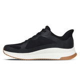 Black athletic shoe with white sole on a white background