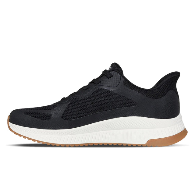 Black athletic shoe with white sole on a white background