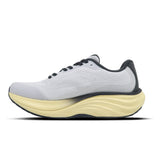 White running shoe with yellow sole on a white background