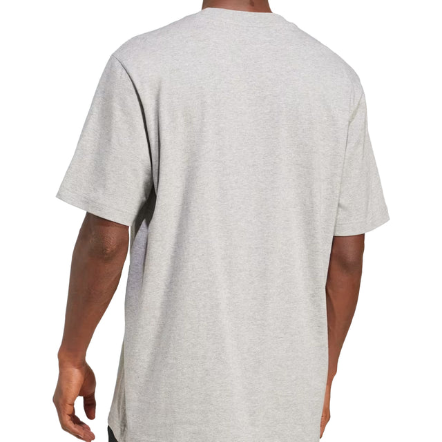 Gray t-shirt worn by a person on a white background