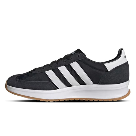 Black Adidas sneaker with white stripes on a white background