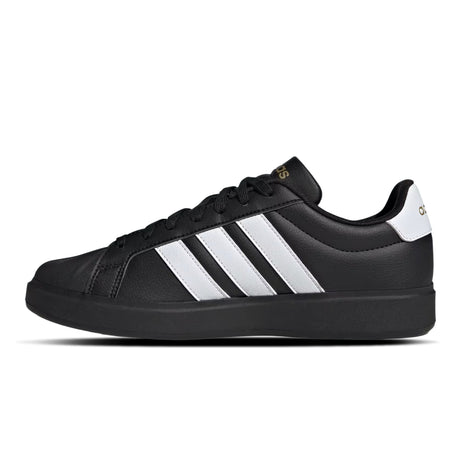 Black Adidas sneaker with white stripes on a white background
