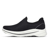 Black slip-on shoe with white sole on a white background