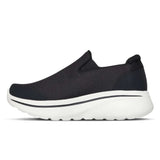 Black slip-on sneaker with white sole on a white background