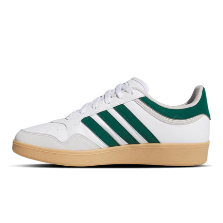 White sneaker with green stripes and brown sole on a white background