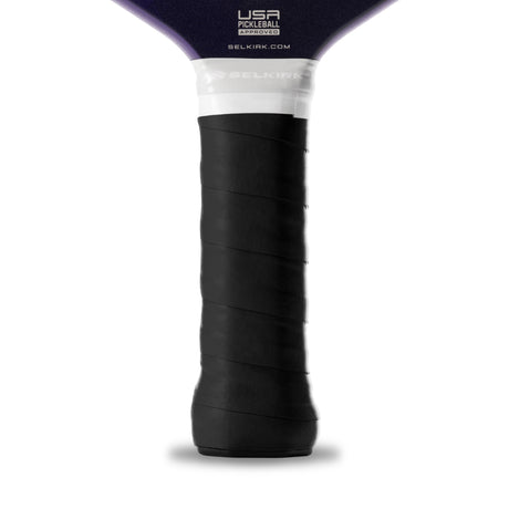 Close-up of a pickleball paddle handle with black grip and white label on a white background