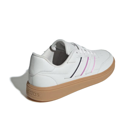 White sneaker with brown sole on a white background