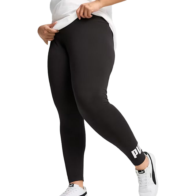 Person wearing black leggings with a brand logo on a white background