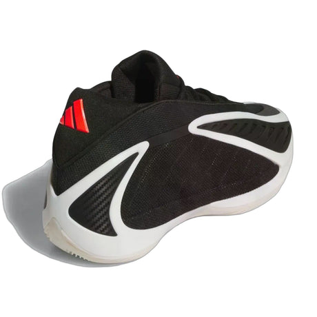 Black and white sneaker with red accents on a white background