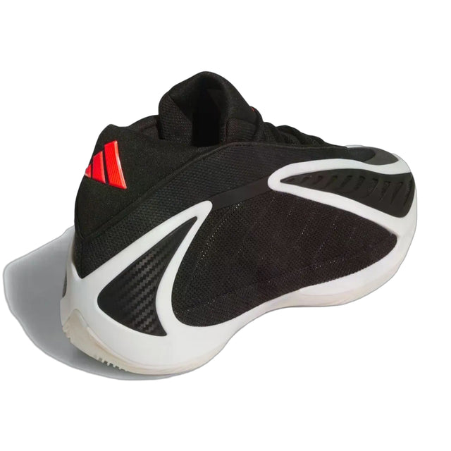 Black and white sneaker with red accents on a white background