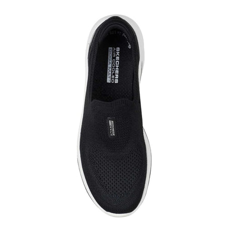 Black slip-on sneaker with white sole on a white background