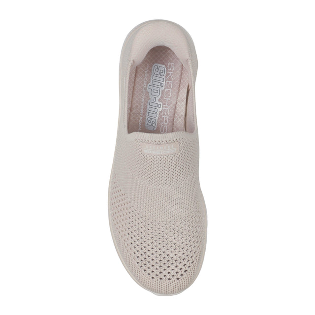 Beige slip-on shoe with 'Skechers' branding on a white background
