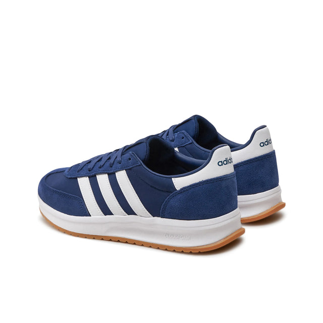 Blue Adidas sneakers with white stripes on a white background