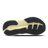 Close-up of a shoe sole with black and gold tread pattern on a white background